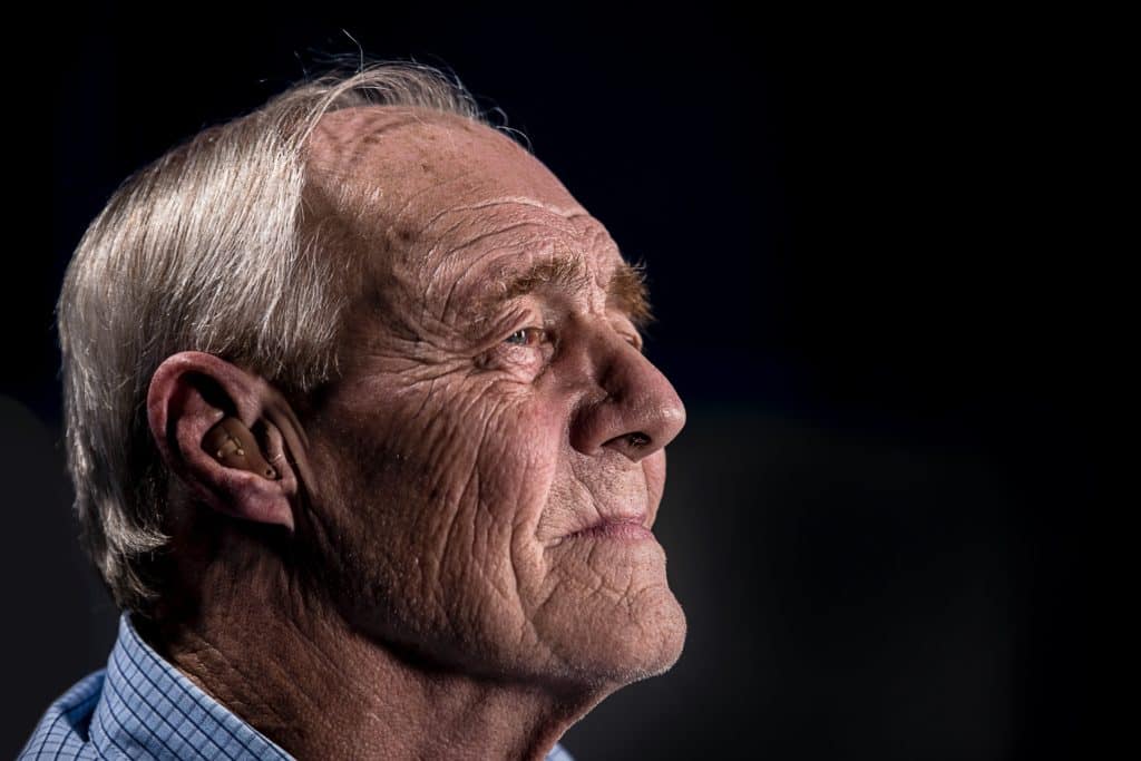 Old man with hearing aid.